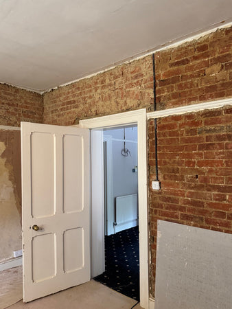 Abingdon - sometimes the plaster on period walls is so loose that it's necessary to go all the way back to the brick. Here, original arches have been revealed over the doorway - this room was probably an extension and the door was possibly a window.