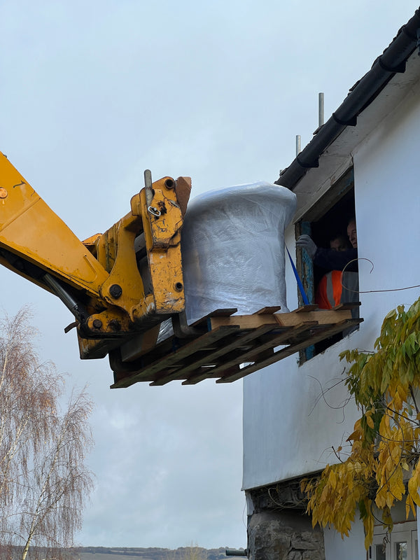 Maidstone - a copper bath being gently manoeuvred into a first floor window
