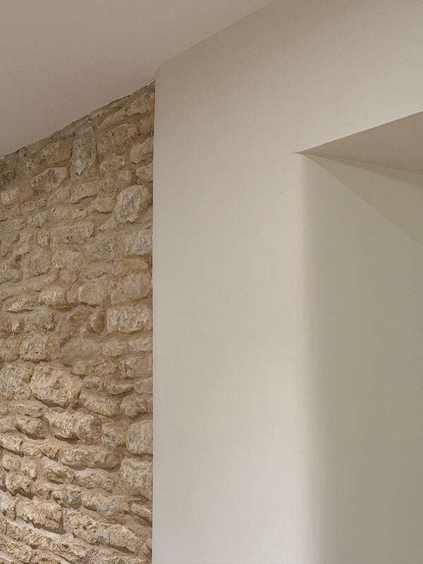 Cotswolds - we left this section of original  stone wall exposed and gently curved the walkthrough to the Dining Room
