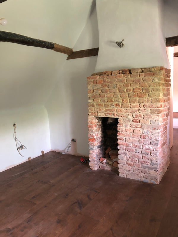 Brockenhurst 1 - bedrooms are starting to come together. Floors are down, walls have been mist-coated, and the unearthed brick fireplace has been cleaned and repointed with lime mortar