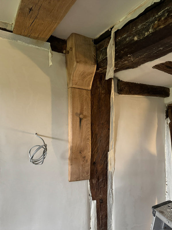 Maidstone - new oak slip to hide plumbing pipes which will be stained to match the original beams